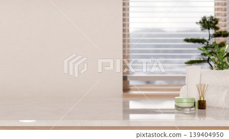 White towel with diffuser and cream jar on marble counter table across window blinds in modern room White towel with diffuser and cream jar on marble counter table across window blinds in modern room 139404950