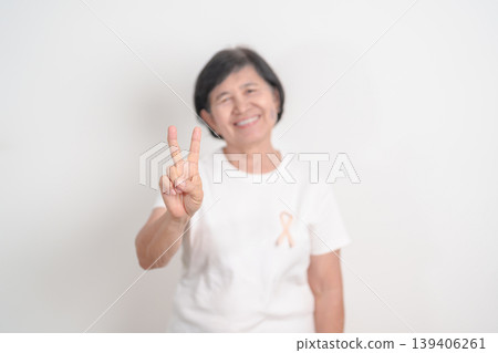 Elderly woman with Peach Ribbon for September Uterine Cancer Awareness month, Endometrial Cancer, Gynecologic, Uterus and Ovaries, Endometriosis, June Vaginal cancer and World cancer day concept 139406261