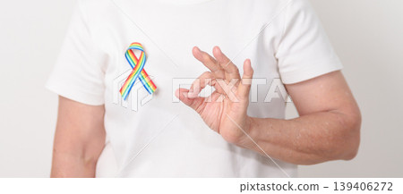 Elderly with LGBTQ Rainbow ribbon for concept of June Pride month, April Autism Awareness, All cancer Awareness, February World Cancer day, October World Hospice and Palliative care day and Survivor Elderly with LGBTQ Rainbow ribbon for concept of June Pride month, April Autism Awareness, All cancer Awareness, February World Cancer day, October World Hospice and Palliative care day and Survivor 139406272