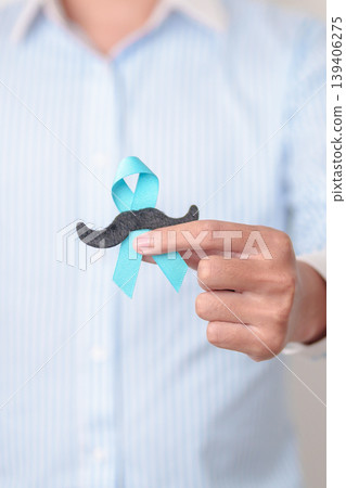 Man with blue Ribbon and mustache for Blue November, November Prostate Cancer Awareness month, World Diabetes day , Men Health month, June International men, Father day. Healthcare and world cancer Man with blue Ribbon and mustache for Blue November, November Prostate Cancer Awareness month, World Diabetes day , Men Health month, June International men, Father day. Healthcare and world cancer 139406275