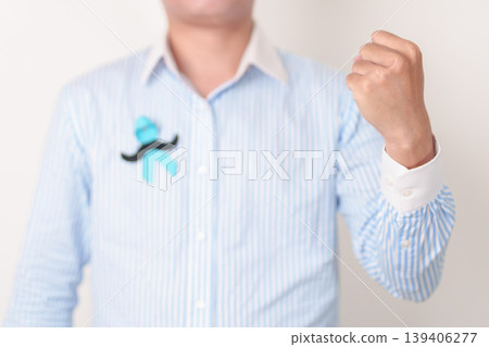 Man with blue Ribbon and mustache for Blue November, November Prostate Cancer Awareness month, World Diabetes day , Men Health month, June International men, Father day. Healthcare and world cancer Man with blue Ribbon and mustache for Blue November, November Prostate Cancer Awareness month, World Diabetes day , Men Health month, June International men, Father day. Healthcare and world cancer 139406277