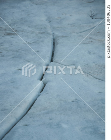 Cracks in lake ice in springtime in Finland Cracks in lake ice in springtime in Finland 139406335