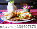 Pork chops steak with toast, french fries, creamy mayonnaise and fresh vegetables with Coconut milk shake in glass 139407373