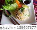 Close up fried rice with Thai cuisine on white plate on wooden table from top view 139407377