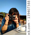 Happy Asian woman taking a photo with analog film camera with travel and journey 139407388