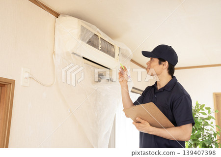 Workers inspecting air conditioners Workers inspecting air conditioners 139407398