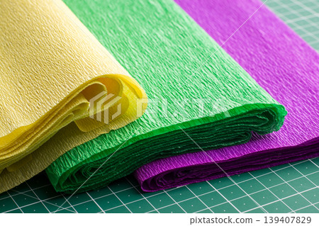 Corrugated rolls of paper of different colour for art work on cutting mat Corrugated rolls of paper of different colour for art work on cutting mat 139407829