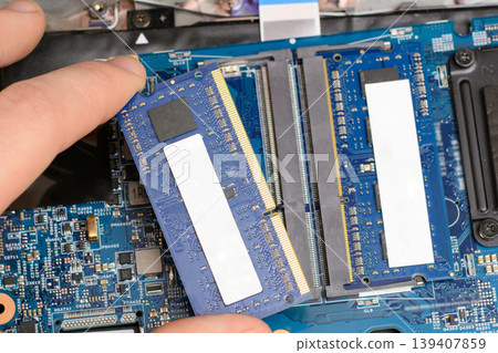 Changing RAM chip on a laptop. Upgrading laptop by adding fast DDR memory module Changing RAM chip on a laptop. Upgrading laptop by adding fast DDR memory module 139407859