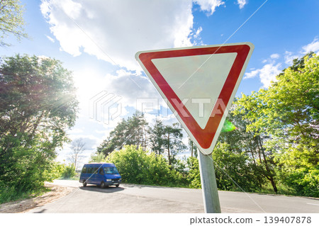 Give way sign on a beautiful sunset background Give way sign on a beautiful sunset background 139407878
