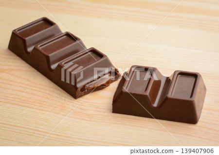 Stuffed bar of dark chocolate lays on table 139407906