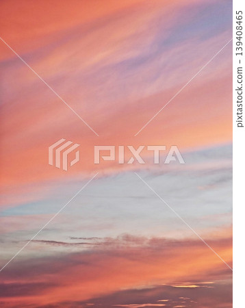 Beautiful evening sky with a soft gradient of orange, pink, and blue before sunset. 139408465