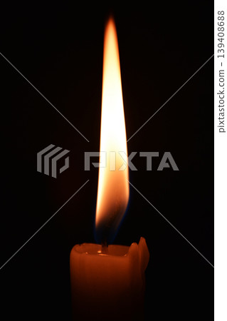 Close up photo of a burning candle on a black background Close up photo of a burning candle on a black background 139408688
