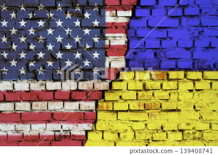 Flags of United States of America and Ukraine on the brick wall with big crack in the middle. Symbol of problems between countries 139408741