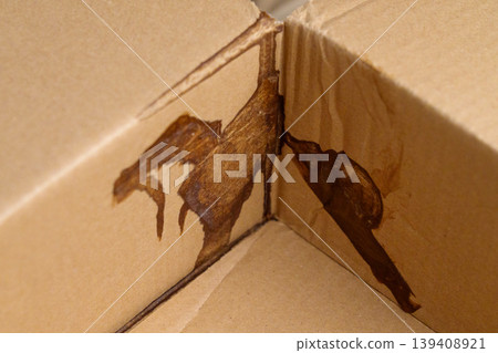 Leakage damage to cardboard parcel box close up Leakage damage to cardboard parcel box close up 139408921