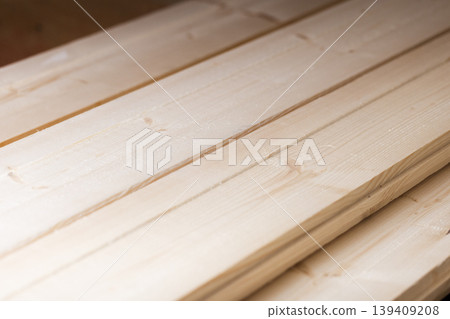 Close-up view of smooth pine lumber planks stacked in a workshop Close-up view of smooth pine lumber planks stacked in a workshop 139409208