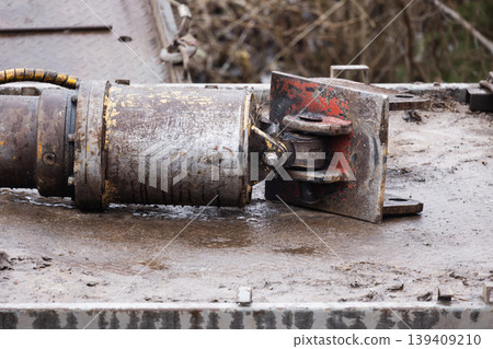 A close-up of a rusted hydraulic cylinder and clevis joint A close-up of a rusted hydraulic cylinder and clevis joint 139409210