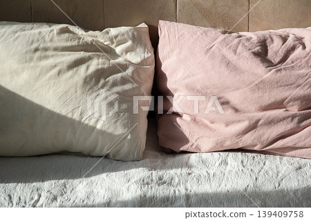 Two soft pillows on bed with morning sunlight. Two soft pillows on bed with morning sunlight. 139409758