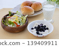 A healthy breakfast of yogurt with salad and blueberries, milk, and bread. 139409911