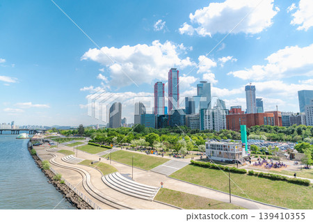 Seoul, South Korea - May. 04, 2026 : Modern skyscrapers in Yeouido district and green trees under blue sky in early summer, Seoul, South Korea 139410355