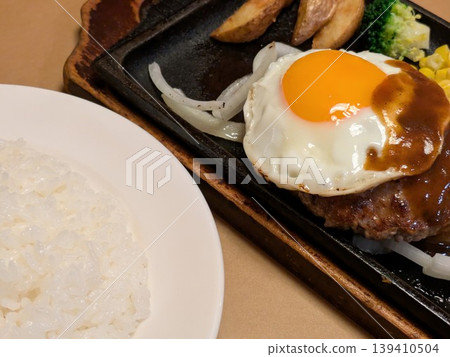 Rice, fried egg, and hamburger steak at a Japanese restaurant. Rice, fried egg, and hamburger steak at a Japanese restaurant. 139410504