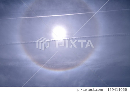 Halo phenomenon: Contrail crossing the sky Halo phenomenon: Contrail crossing the sky 139411066