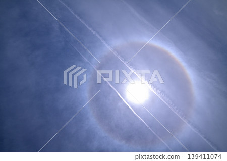 Halo phenomenon: Contrail crossing the sky Halo phenomenon: Contrail crossing the sky 139411074