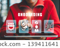 Businessperson interacts with digital onboarding icons on a tablet, highlighting modern technology in human resources. 139411641