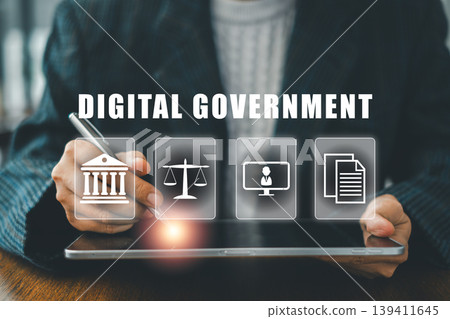 Businessman interacts with digital government icons on a tablet, symbolizing modern e-government services and online solutions. Businessman interacts with digital government icons on a tablet, symbolizing modern e-government services and online solutions. 139411645