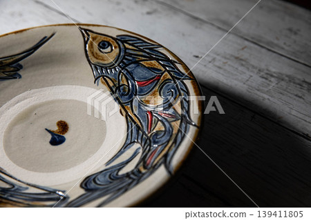 Okinawan traditional craft: Yachimun fish pattern plate Okinawan traditional craft: Yachimun fish pattern plate 139411805