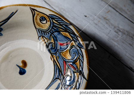 Okinawan traditional craft: Yachimun fish pattern plate Okinawan traditional craft: Yachimun fish pattern plate 139411806
