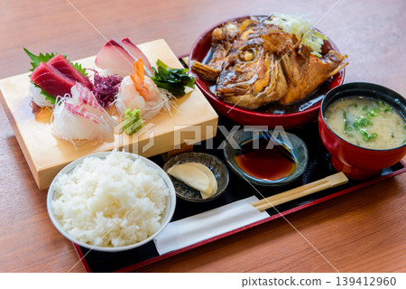 Image of a Japanese set meal with sashimi and boiled fish. Image of a Japanese set meal with sashimi and boiled fish. 139412960