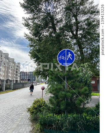 Round blue road sign of pedestrian and cycle path, shared sidewalk. Vertical photo Round blue road sign of pedestrian and cycle path, shared sidewalk. Vertical photo 139413226