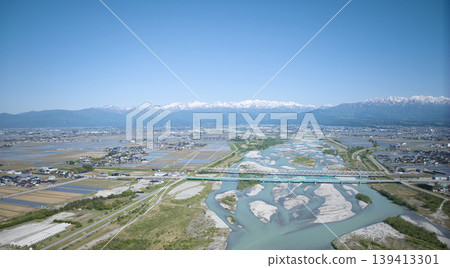 A view from around the mouth of the Kurobe River in May, the rice planting season. A view from around the mouth of the Kurobe River in May, the rice planting season. 139413301