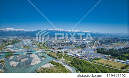 A view from around the mouth of the Kurobe River in May, the rice planting season. A view from around the mouth of the Kurobe River in May, the rice planting season. 139413302