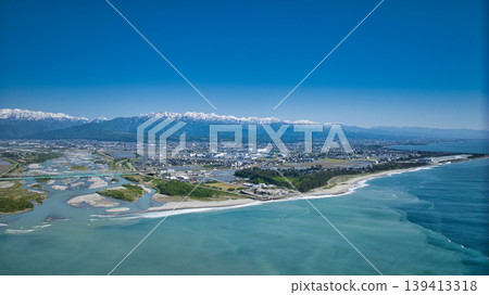 A view from around the mouth of the Kurobe River in May, the rice planting season. A view from around the mouth of the Kurobe River in May, the rice planting season. 139413318