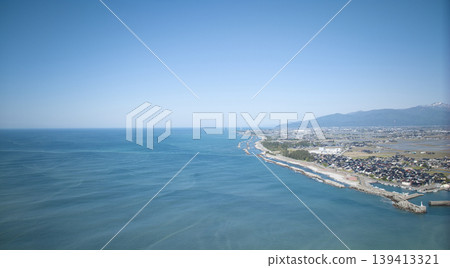 A view from around the mouth of the Kurobe River in May, the rice planting season. A view from around the mouth of the Kurobe River in May, the rice planting season. 139413321