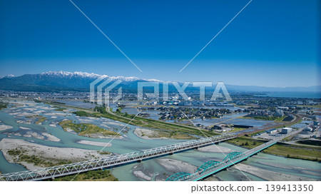 A view from around the mouth of the Kurobe River in May, the rice planting season. A view from around the mouth of the Kurobe River in May, the rice planting season. 139413350