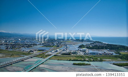 A view from around the mouth of the Kurobe River in May, the rice planting season. A view from around the mouth of the Kurobe River in May, the rice planting season. 139413351