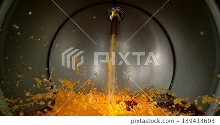 Gasoline jet pouring into metal fuel tank, inside view with dynamic splash and turbulence. Concept of refueling, fuel storage and energy supply, industrial environment. 139413603