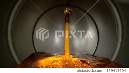 Gasoline jet pouring into metal fuel tank, inside view with dynamic splash and turbulence. Concept of refueling, fuel storage and energy supply, industrial environment. 139413604