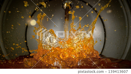 Gasoline jet pouring into metal fuel tank, inside view with dynamic splash and turbulence. Concept of refueling, fuel storage and energy supply, industrial environment. Gasoline jet pouring into metal fuel tank, inside view with dynamic splash and turbulence. Concept of refueling, fuel storage and energy supply, industrial environment. 139413607