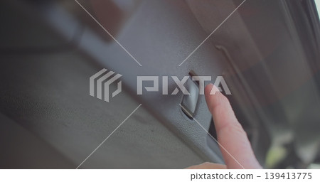 Close up woman hand presses car trunk close button and the trunk of the car is closed. Car trunk closing button. Close up woman hand presses car trunk close button and the trunk of the car is closed. Car trunk closing button. 139413775