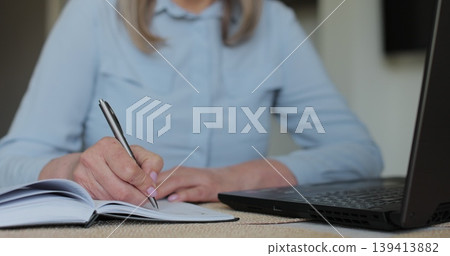 Hand and writing with senior woman in home. Contract, laptop and will with old person in retirement apartment for budget, bank finance. Hand and writing with senior woman in home. Contract, laptop and will with old person in retirement apartment for budget, bank finance. 139413882