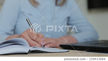 Hand and writing with senior woman in home. Contract, laptop and will with old person in retirement apartment for budget, bank finance. Hand and writing with senior woman in home. Contract, laptop and will with old person in retirement apartment for budget, bank finance. 139413884