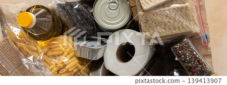 Canned goods, cereals, and pasta stored for quarantine and isolation, ensuring long-term survival and food security at home, survival during military operations, the concept of stay at home, banner 139413907