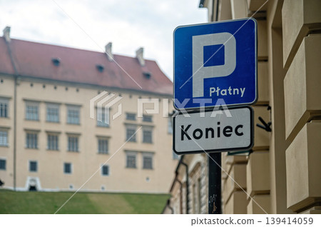 Parking sign in Krakow, Poland near historical buildings in cloudy weather Parking sign in Krakow, Poland near historical buildings in cloudy weather 139414059