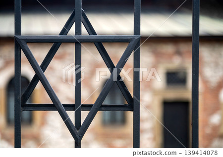 Star of David symbol seen through metal bars in historical setting Star of David symbol seen through metal bars in historical setting 139414078
