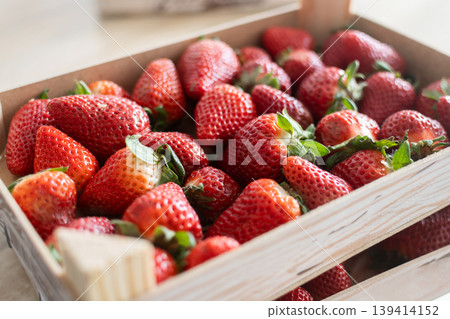 Fresh strawberries on wooden boxes Fresh strawberries on wooden boxes 139414152