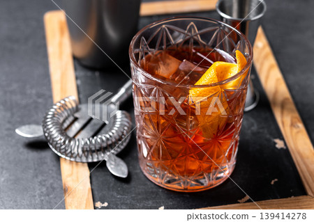 Old Fashioned Cocktail with Orange Peel on black background Old Fashioned Cocktail with Orange Peel on black background 139414278