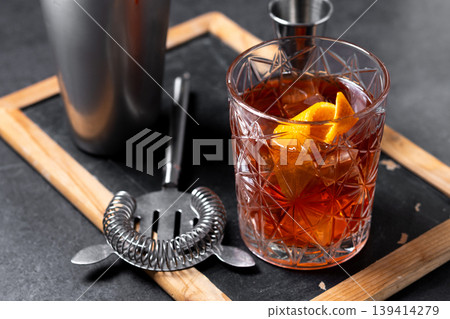 Old Fashioned Cocktail with Orange Peel on black background Old Fashioned Cocktail with Orange Peel on black background 139414279
